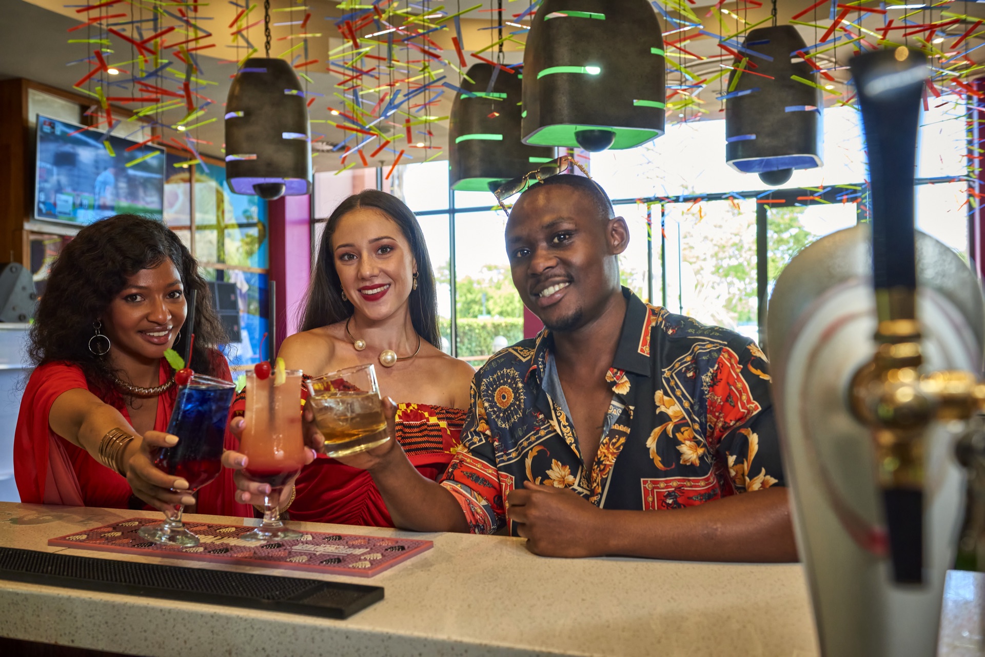 Friends toasting cocktails at the Rio casino bar, Klerksdorp
