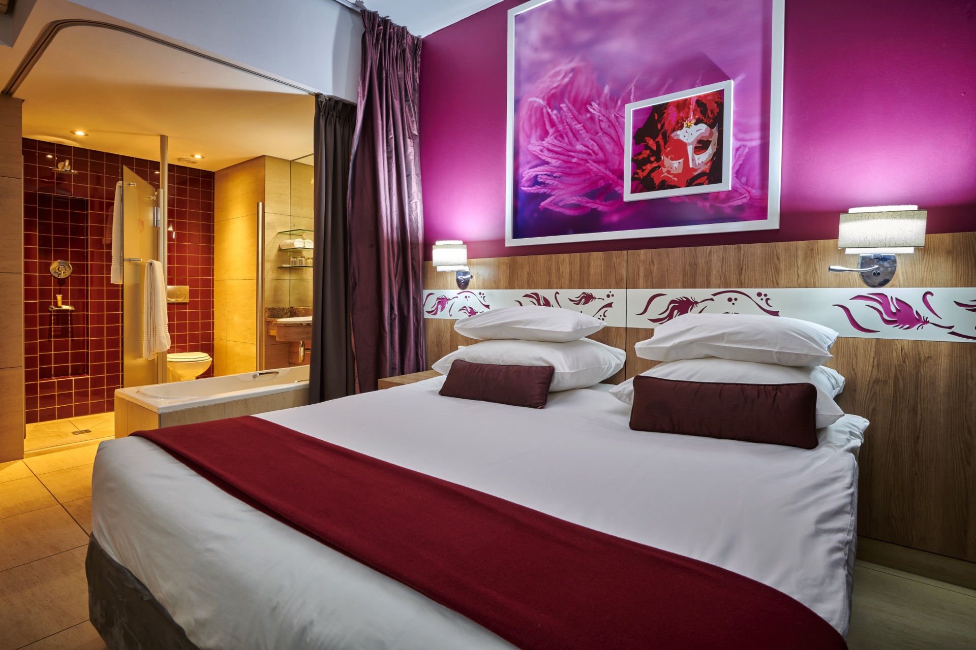 Carnival-themed guest room with a double bed and mask artwork at Rio, a 3-star Peermont hotel in Klerksdorp