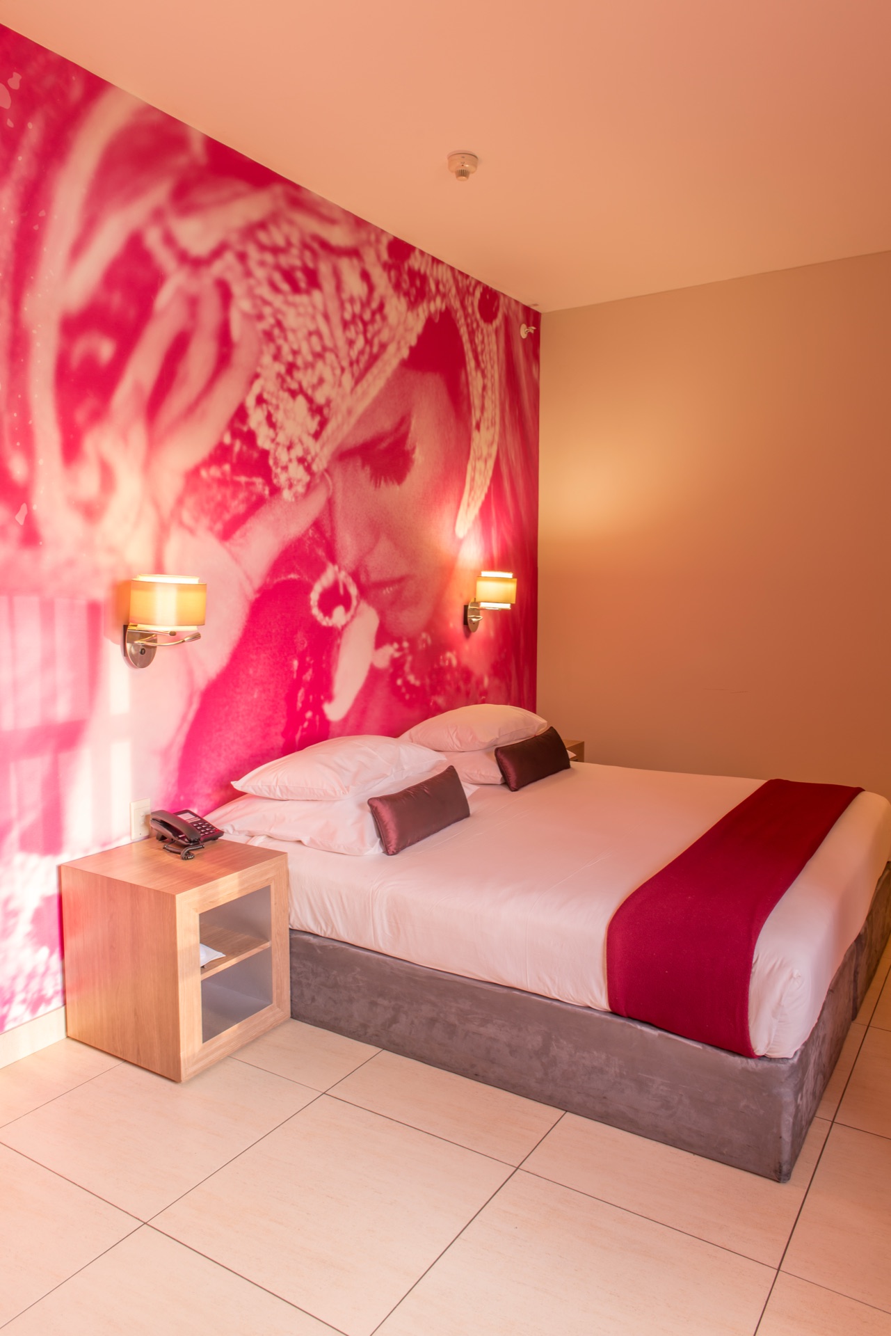 Universal Accessible room with king bed against a carnival mural at Rio, Klerksdorp