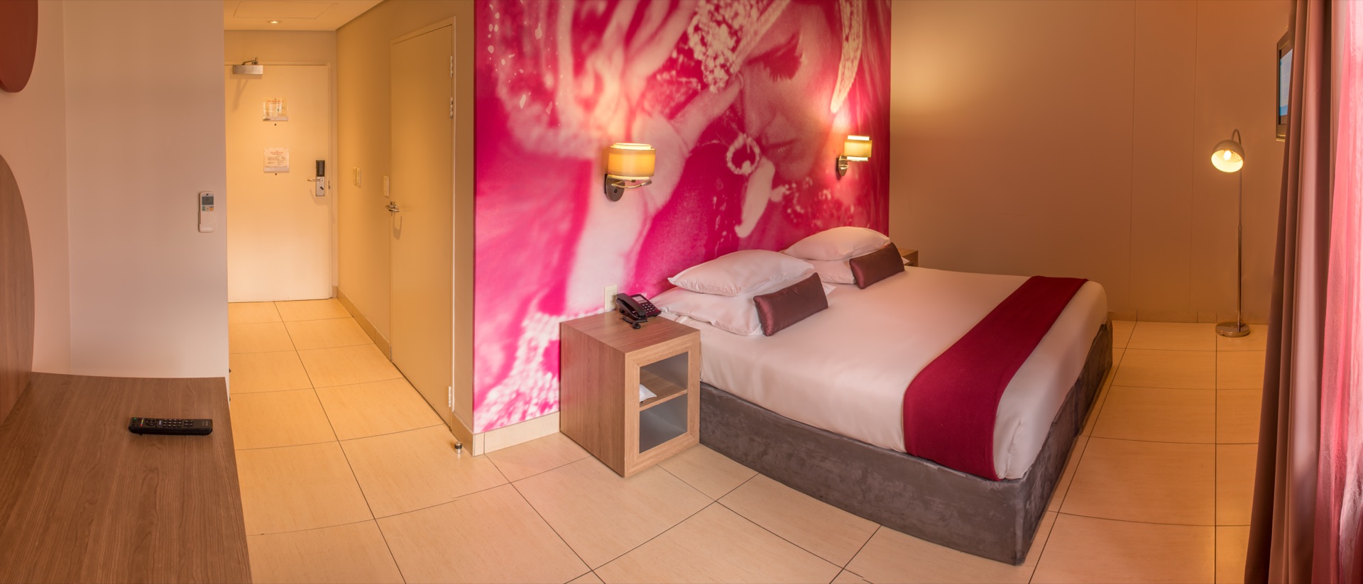 Panoramic accessible room showing entrance, bed and mural at Rio, Klerksdorp